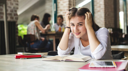 lovely teen with books posing camera